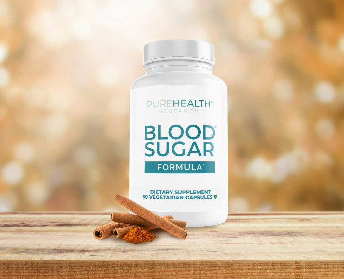 A bottle of PureHealth Research Blood Sugar Formula on a wooden surface, promoting the best supplements for blood sugar with cinnamon in the foreground.