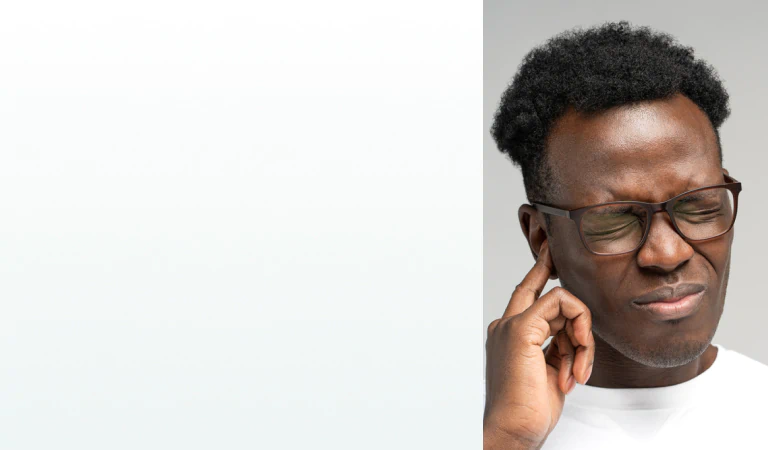 A man pressing his finger to his ear in discomfort, representing the need for supplements for hearing loss.